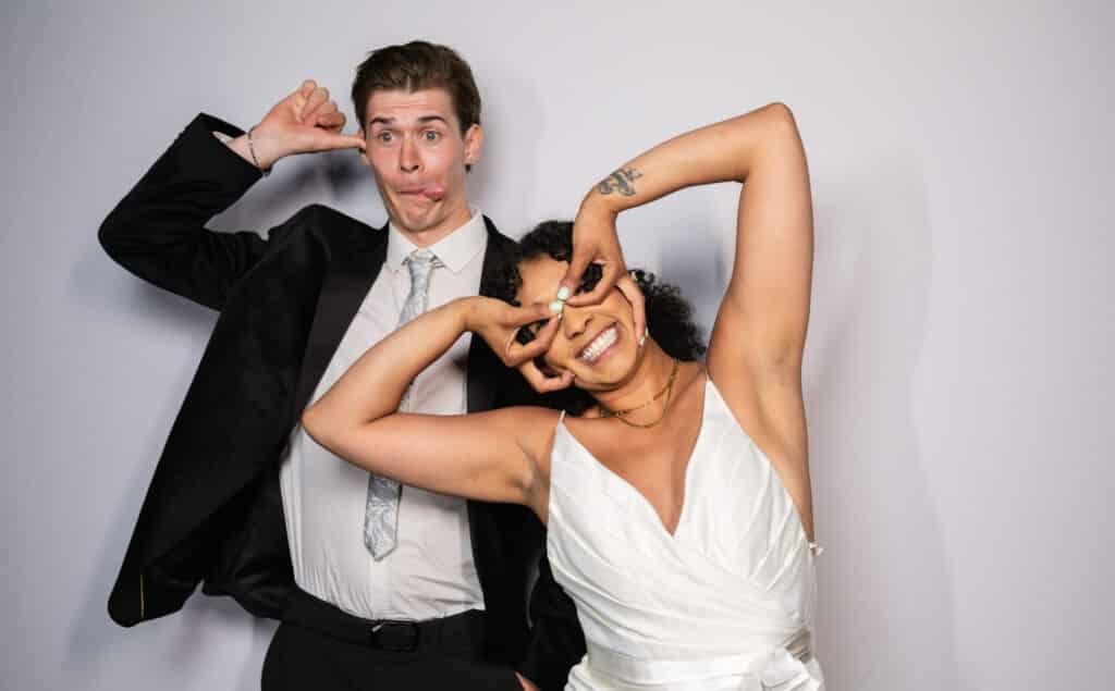 Wedding couple posing with silly poses for a photo