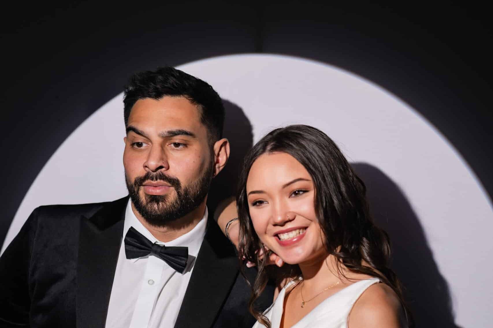 Wedding couple posing for a photo in spotlight